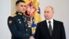 Russian President Vladimir Putin shakes hands with Lieutenant Colonel Sultan Khashegulkov during a ceremony to present Gold Star medals to service members in Moscow on December 8.