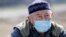 Kazakhstan - A man wearing a protective mask is seen near a check point, following the Kazakh state emergency commission's decision to lock down Almaty to prevent the spread of coronavirus disease (COVID-19), on the outskirts of Almaty, Kazakhstan March 1