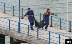 Рятувальники несуть фрагменти і залишки, знайдені на місці катастрофи літака Ту-154 поблизу Сочі. 25 грудня 2016 року