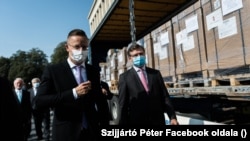 Петер Сійярто (л) і Дмитро Кулеба (п) під час передачі апаратів ШВЛ й іншої допомоги від уряду Угорщини, Ужгород, 23 серпня 2020 року