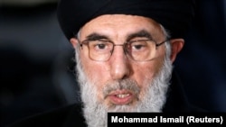 Former Afghan warlord Gulbuddin Hekmatyar speaks to the media after arriving to register as a candidate for the presidential election at the Independent Election Commission in Kabul on January 19.