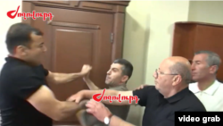 Armenia - A screenshot of Armlur.am video of Artur Chakoyan (left) assaulted by officials from the Nor Nork district of Yerevan, April 30, 2025.