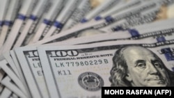 This photo illustration shows US dollar notes at a foreign currency dealer in Ampang on August 14, 2015.