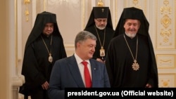 П'ятий президент України Петро Порошенко (ліворуч) і представники Вселенського патріарха Варфоломія митрополит Гальський Еммануїл, екзархи Іларіон та Даниїл (ззаду) під час зустрічі з делегацією Вселенського патріархату, Київ, 27 липня 2018 року