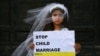 ITALY -- A young actress plays the role of Giorgia, 10, forced to marry Paolo, 47, during a happening organised by Amnesty International to denounce child marriage, on October 27, 2016 in Rome.