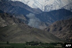 Smoke rises after an air strike on Islamic State (IS) militants in an operation in the Achin district of Nangarhar Province on April 14, one day after the dropping of the MOAB bomb in the same area.