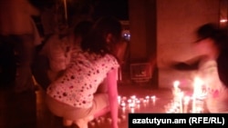 Armenia - Candles are put in a silent vigil otuside the Harsnakar restaurant in Yerevan, 30Jun2012.
