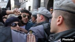 Armenia - Riot police clash with pro-Ukraine protesters outside the Russian Embassy in Yerevan, 5Mar2014.