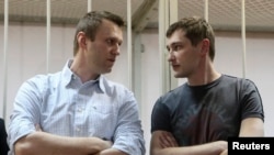 Aleksey Navalnıy (sol tarafta) ve qardaşı Оleg Navalnıy mahkeme salonında, Moskva, 2014 senesi dekabr 30 künü