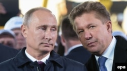 Орус президенти Владимир Путин менен "Газпромдун" президенти Алексей Миллер.