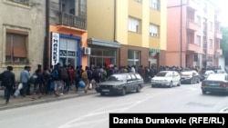 Police escort migrants to the Vucjak camp near Bihac on October 15.