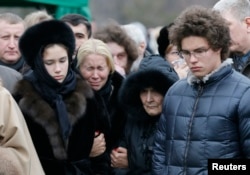 Nemtsov's former partner, Yekaterina Odintsova (second from left), their children Anton (right) and Dina, and Nemtsov's mother, Dina Eidman, attend his funeral in Moscow on March 3.
