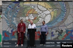 Олександр Усик з Владиславом Чечоткіним та Річардом Бренсоном під час презентації реконструйованої мозаїки «Боривітер»