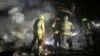 Ukrainian firefighters work on in a residential area hit by a Russian air strike on September 23. 