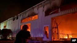 Emergency services personnel try to extinguish a fire following a Russian attack in Odesa on May 1.