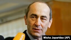 ARMENIA -- Then Armenian President Robert Kocharian talks to the media at a polling station in Yerevan, February 19, 2008