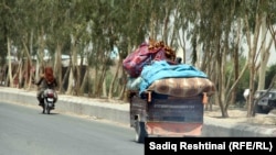 An Afghan family flees the fighting in Kandahar on July 10.