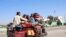 Internally displaced people flee from Lashkar Gah during the ongoing clashes between Taliban fighters and Afghan security forces on October 14.