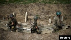 Nagorno-Karabakh -- Ethnic Armenian soldiers walk in a trench at an artillery positions near the town of Martuni, April 7, 2016