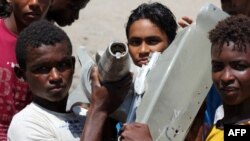 کودکان یمنی با قطعاتی که ظاهرا متعلق به یک هواپیمای سقوط کرده است