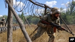 Soldiers from Ukraine's 65th Mechanized Brigade train in the Zaporizhzhia region on August 13.