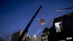 This handout photograph taken and released by Ukrainian Emergecy Service on October 11, 2023 show rescuers clear debris at a lyceum, after a Russian strike in Nikopol, Dnipropetrovs region, amid the Russian invasion of Ukraine.