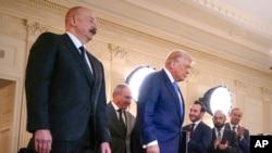 U.S. - Azerbaijan's President Ilham Aliyev, Armenian Prime Minister Nikol Pashinian and President Donald Trump arrive for a signing ceremony at the White House, August 8, 2025.
