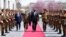 U.S. Defense Secretary Lloyd Austin (center) walks past a guard of honor during his visit to Kabul on March 21. 