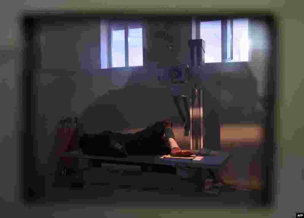 A wounded Afghan man gets his leg X-rayed at the Wazir Akbar Khan hospital following the attack.