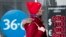 RUSSIA -- A woman walks past an exchange office screen showing the currency exchange rates of U.S. Dollar and Euro to Russian Ruble in Moscow, March 9, 2020