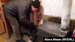 Мужчина, живущий в поселке Шахан Карагандинской области, топит самодельную печку-буржуйку в квартире многоэтажного дома. 