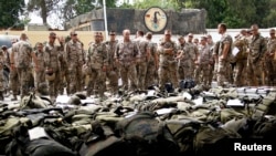 German soldiers who have completed their term of deployment in Afghanistan wait for their luggage to go through a security check before their flight back to Germany at the air base in Termez in April 2010.