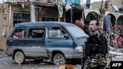 Afghan security personnel arrive on the scene after two blasts ripped through the city of Bamiyan on November 24.