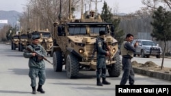 Foreign security personnel and Afghan police arrive at the site of the attack in Kabul on March 6.