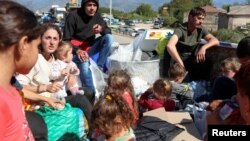 Armenia - Refugees from Nagorno-Karabakh sit in the back of a truck upon their arrival in the border village of Kornidzor, September 27, 2023.