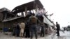Afghan security officials inspect the scene of a bomb blast in Jalalabad on February 20.