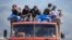Refugees from Nagorno-Karabakh ride on a truck arriving at the border village of Kornidzor, Armenia, on September 27.