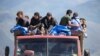 Armenia - Refugees from Nagorno-Karabakh region ride in a truck upon their arrival at the border village of Kornidzor, September 27, 2023. 