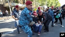 Armenia - Police detain a protester during a rally against Prime Minister Nikol Pashinian in Yerevan, May 27, 2024.