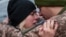 A Ukrainian soldier says goodbye to his wife after a short break from his frontline duties at the train station in Kramatorsk on February 14.