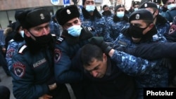 Armenia -- Police detain an opposition protester outside the parliament building in Yerevan, December 28, 2020.