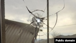 Armenia - A bullet hole on a window glass in a house in the village of Khnatsakh, March 31, 2025.