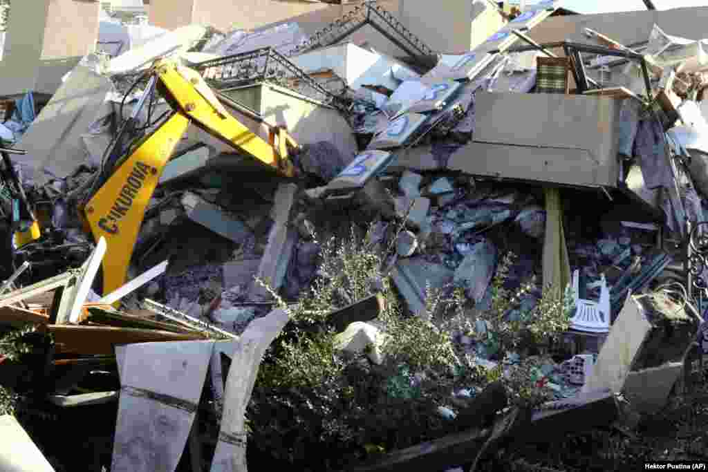 A crumpled building in the Adriatic port city of Durres, 30 kilometers west of the capital, as an excavator works to try to extract survivors.&nbsp;