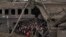 Ирпень, 5 марта 2022 года. Люди на выходе из города прячутся под полуразрушенным атомобильным мостом. Иллюстративное фото