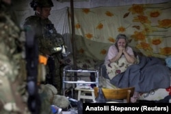 Поліцейські з «Білого янгола» умовляють жінку евакуюватись із міста, Покровськ, 12 квітня 2025 року