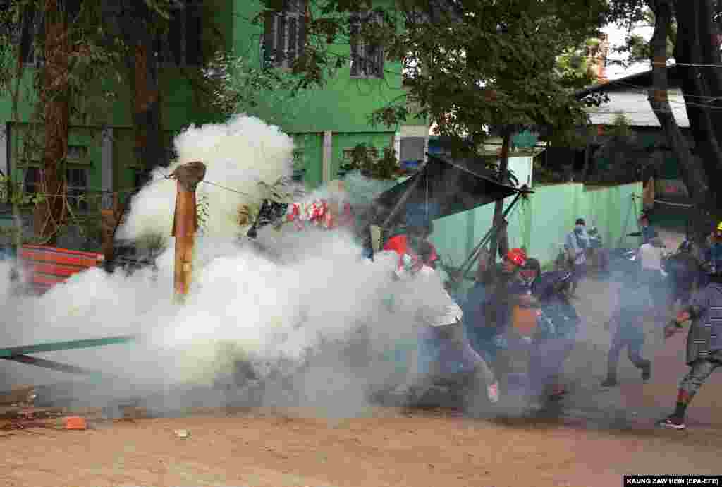 Демонстранти втікають від сльозогінного газу, випущеного поліцією під час протесту проти військового перевороту в Мандалаї, М&#39;янма, 20 лютого 2021 року