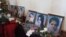 Armenia - Flowers put by the pictures of six members of an Armenian family murdered in Gyumri during their funeral, 15Jan2015.