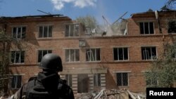 A Ukrainian serviceman surveys the aftermath of a Russian air strike on a hospital in Kharkiv on July 25.