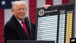 US President Donald Trump displays chart listing new tariff rates. (file photo)