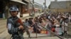 A Taliban fighter stands guard as Muslims offer Friday noon prayers at a Kabul mosque on October 1.